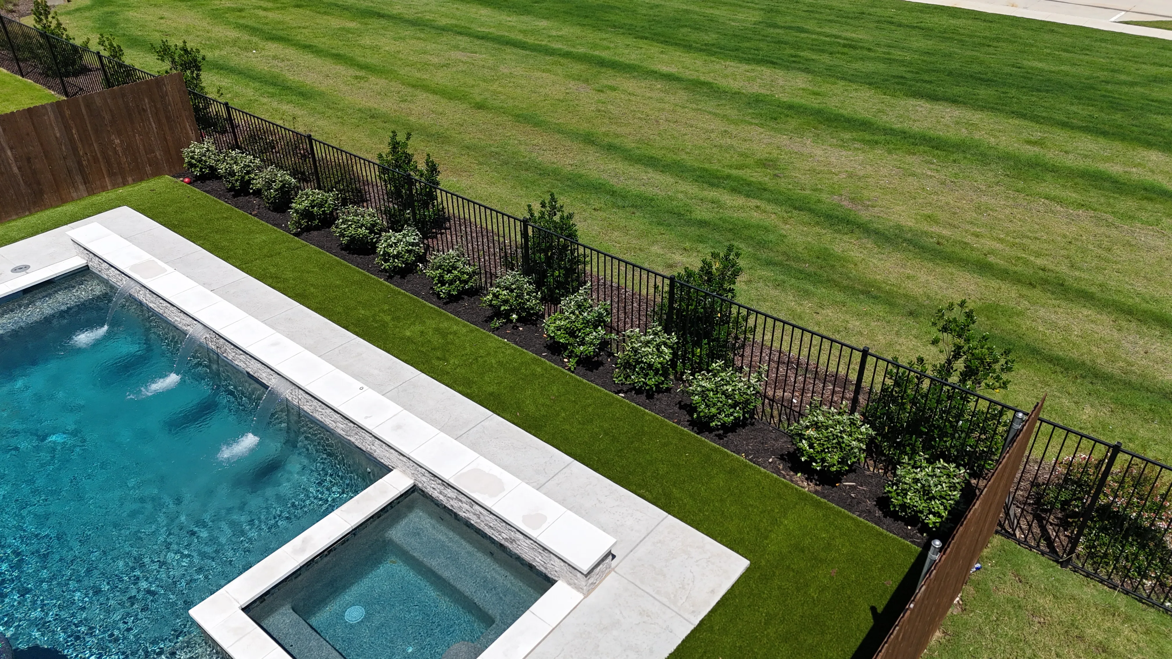Complete backyard upgrade in a DFW master-planned community: 700 SF turf, privacy bushes, fence-line flower bed feature 2