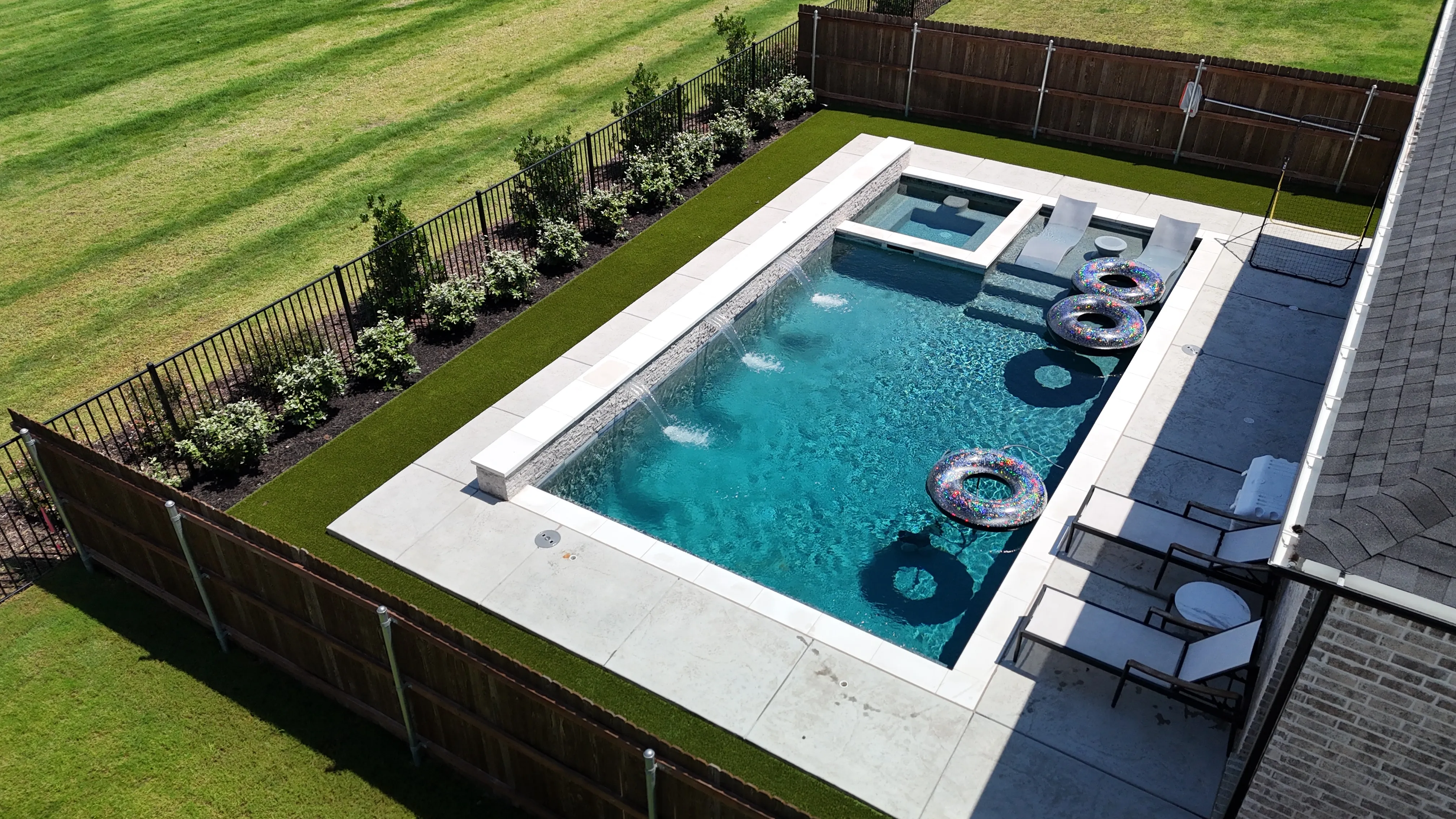 Complete backyard upgrade in a DFW master-planned community: 700 SF turf, privacy bushes, fence-line flower bed feature 3