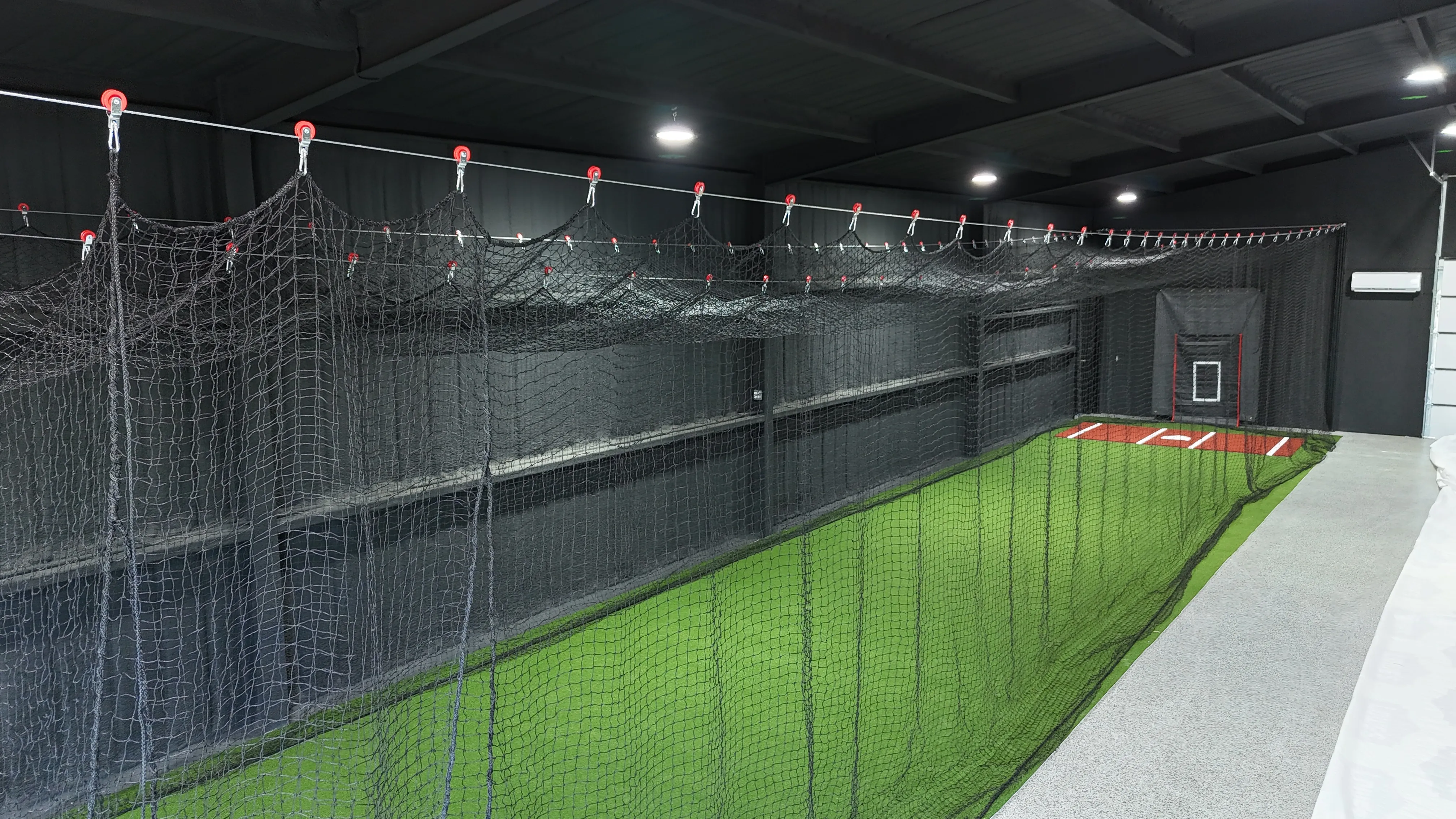 Aledo backyard barn batting cage: 70' full-length retractable Cimarron net, Performance Pro turf, clay batter's box feature 3