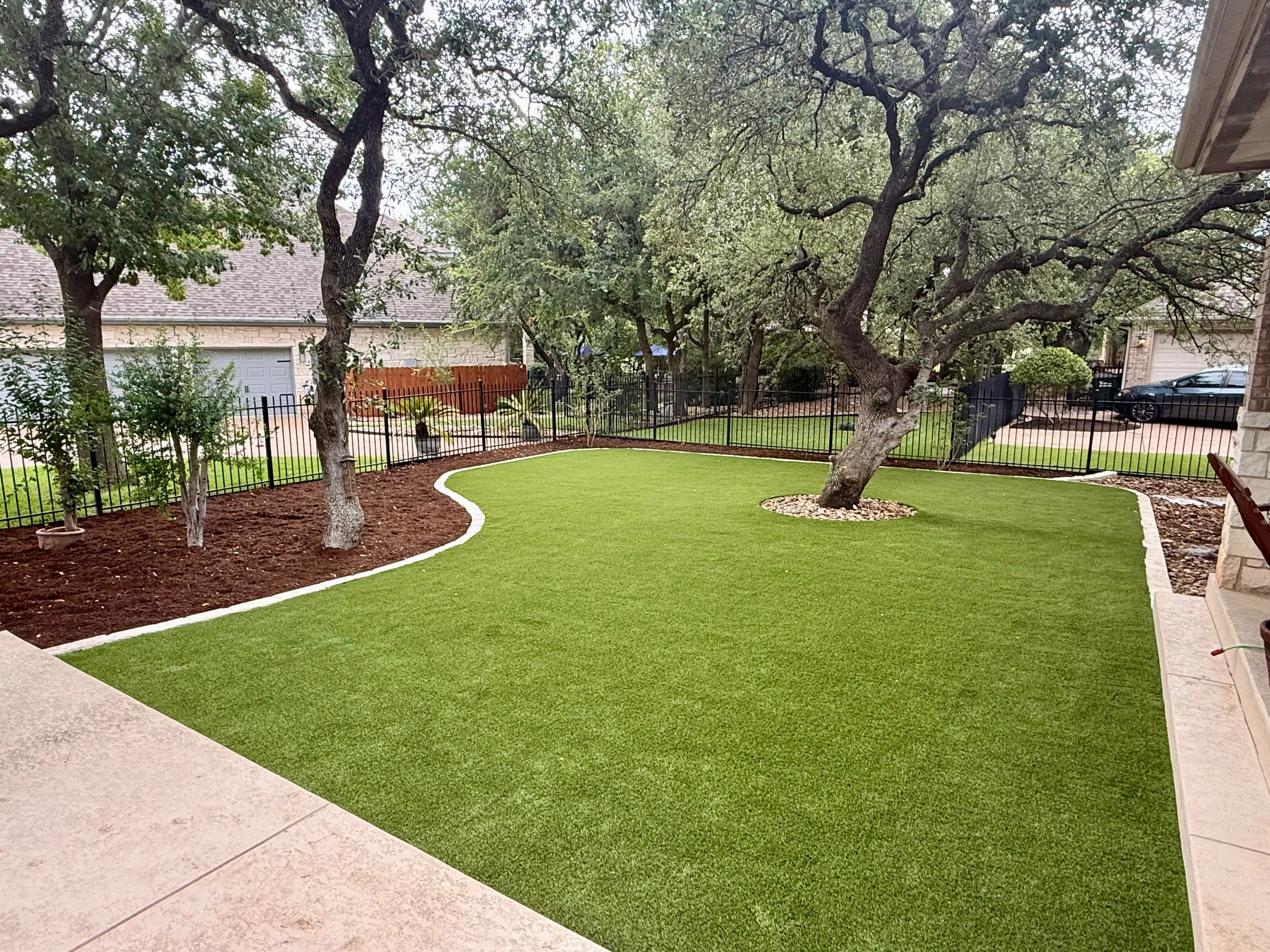 Georgetown complete backyard renovation: turf, limestone, and living space under the live oaks feature 3