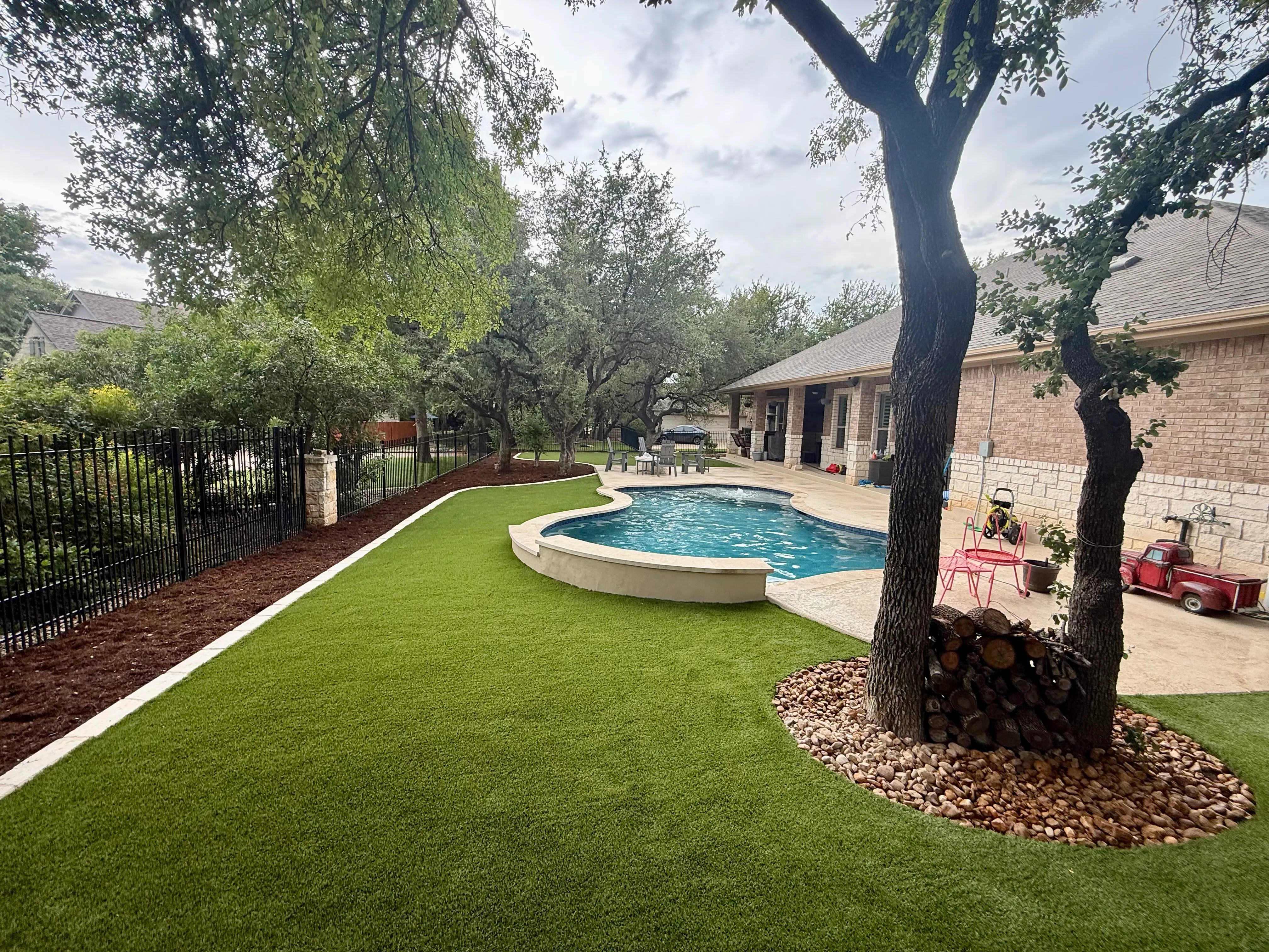 After 4 — Georgetown complete backyard renovation: turf, limestone, and living space under the live oaks