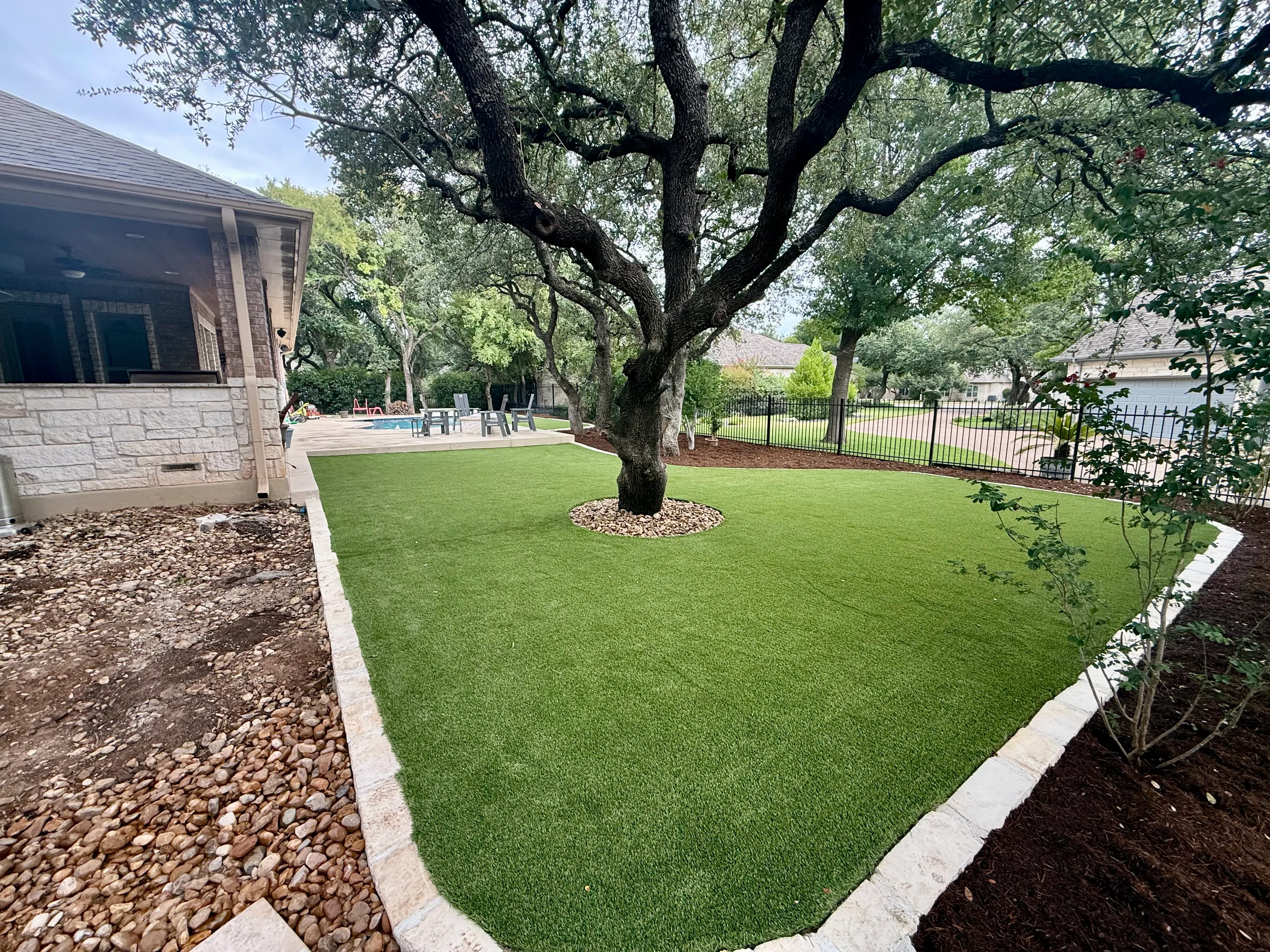 After 6 — Georgetown complete backyard renovation: turf, limestone, and living space under the live oaks