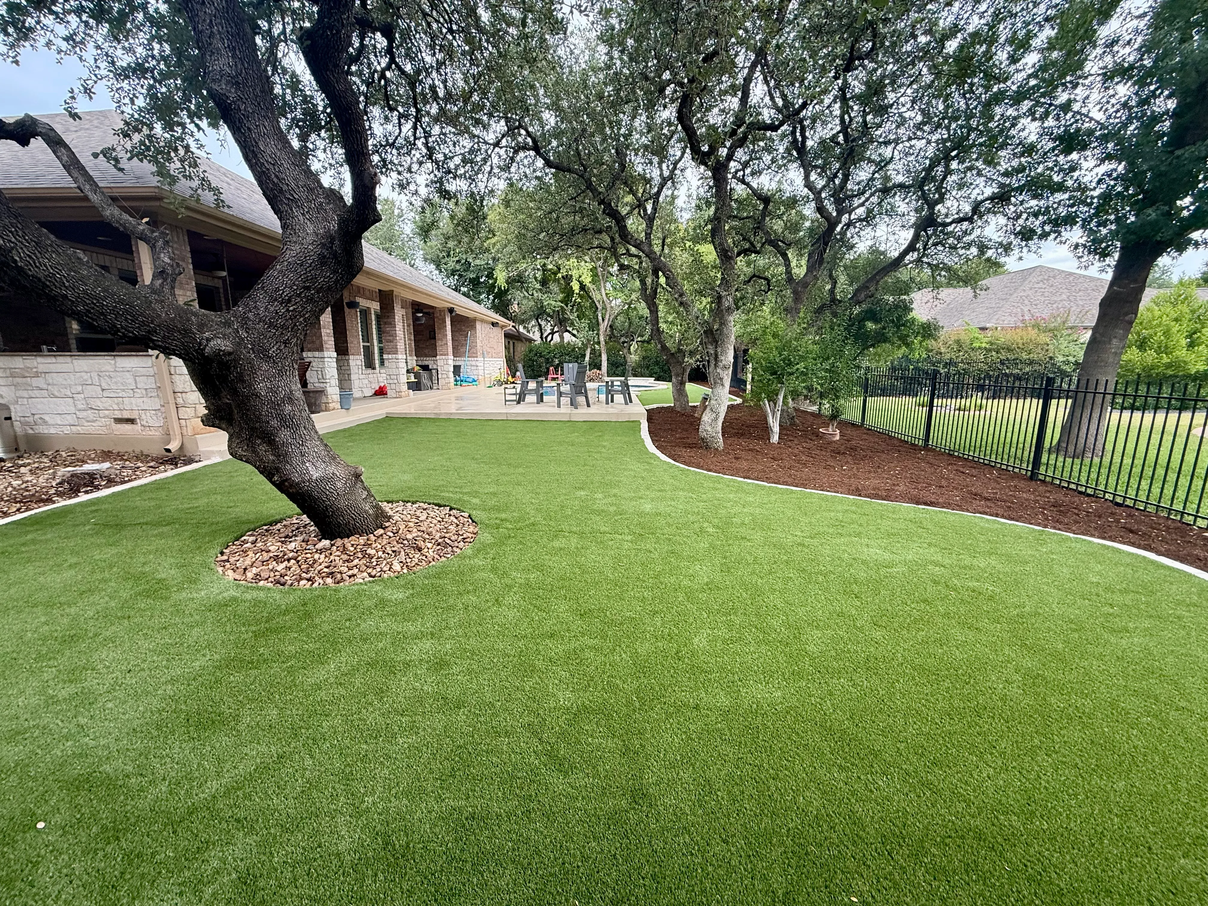 After 7 — Georgetown complete backyard renovation: turf, limestone, and living space under the live oaks