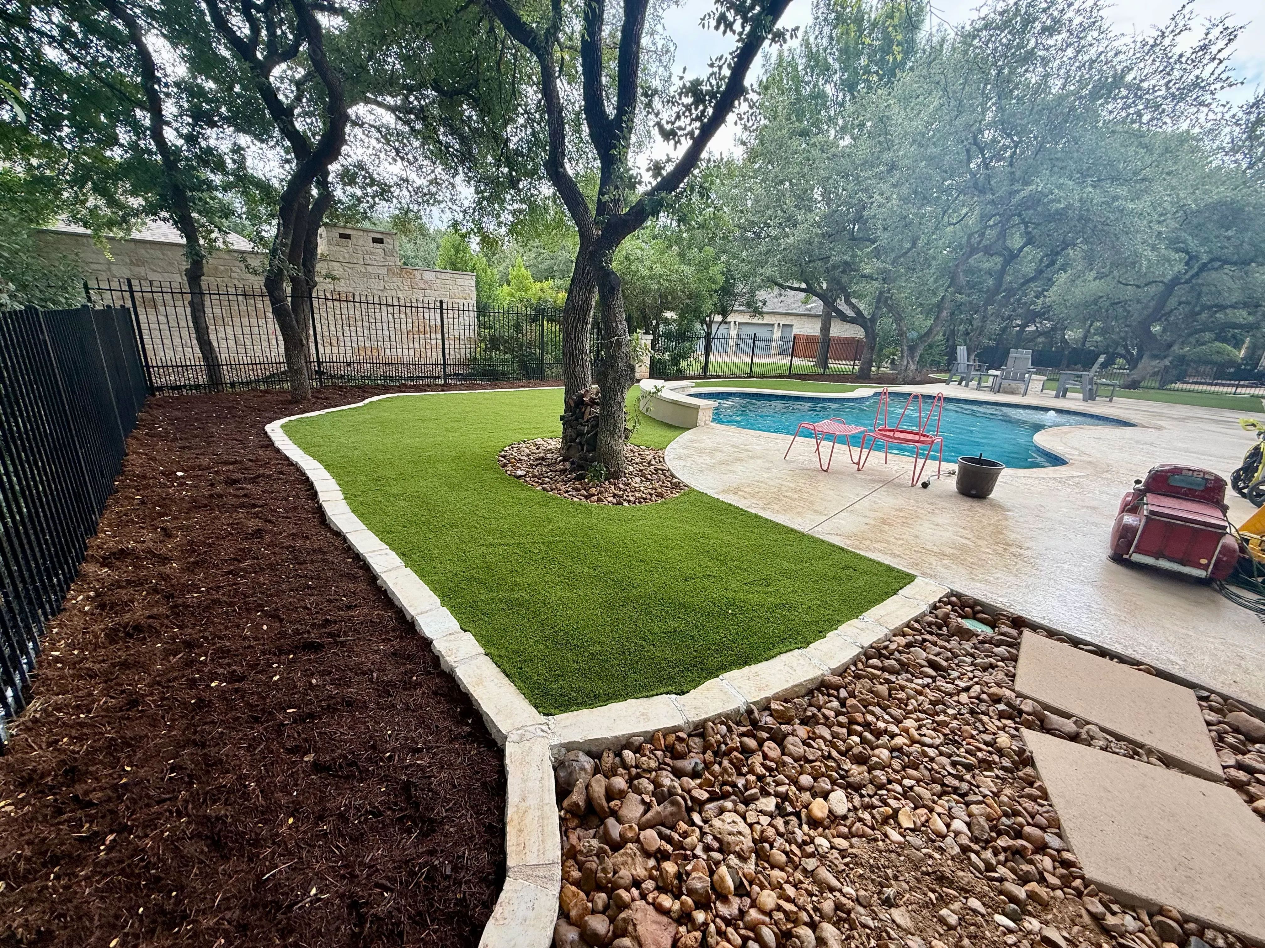After 9 — Georgetown complete backyard renovation: turf, limestone, and living space under the live oaks
