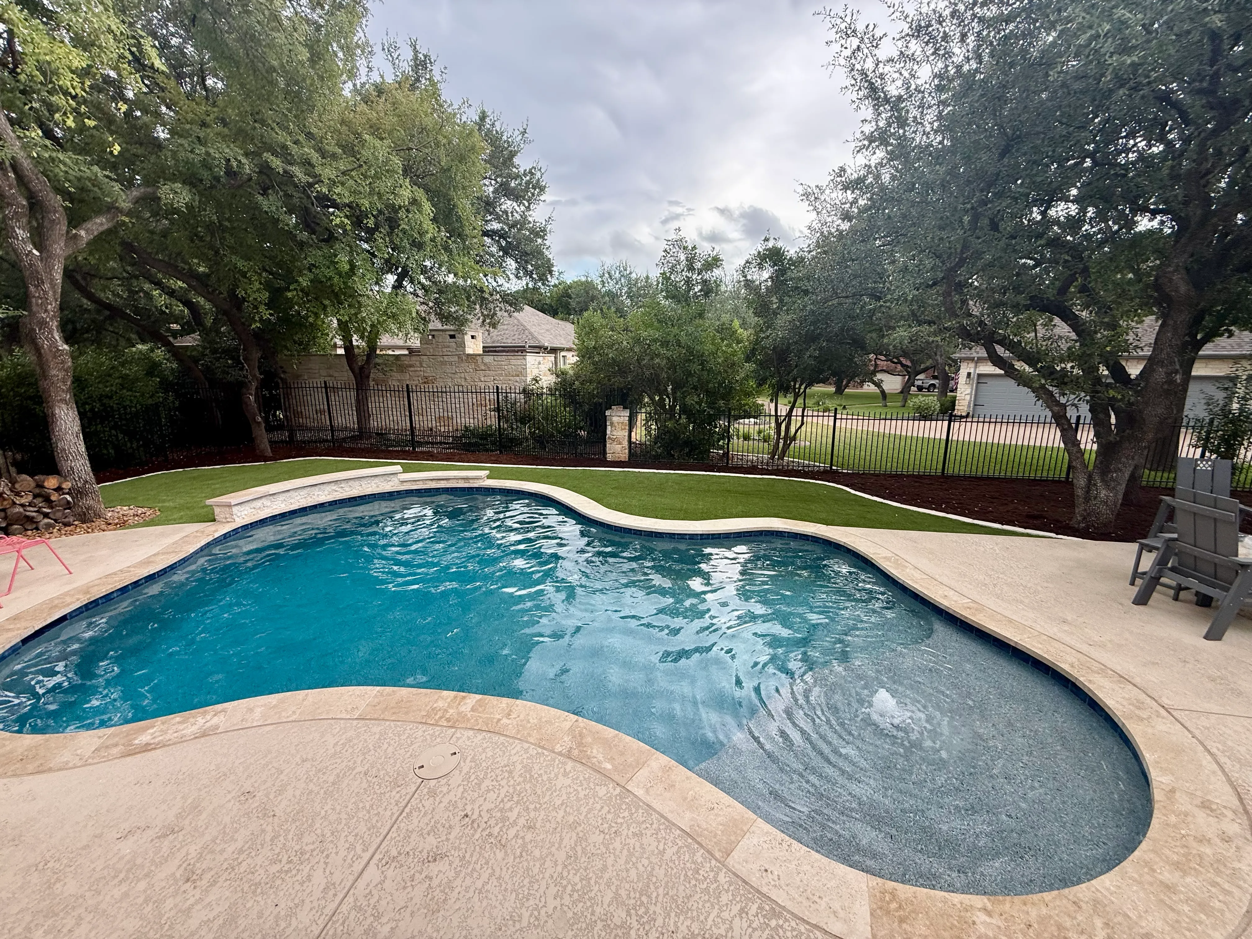 After 10 — Georgetown complete backyard renovation: turf, limestone, and living space under the live oaks