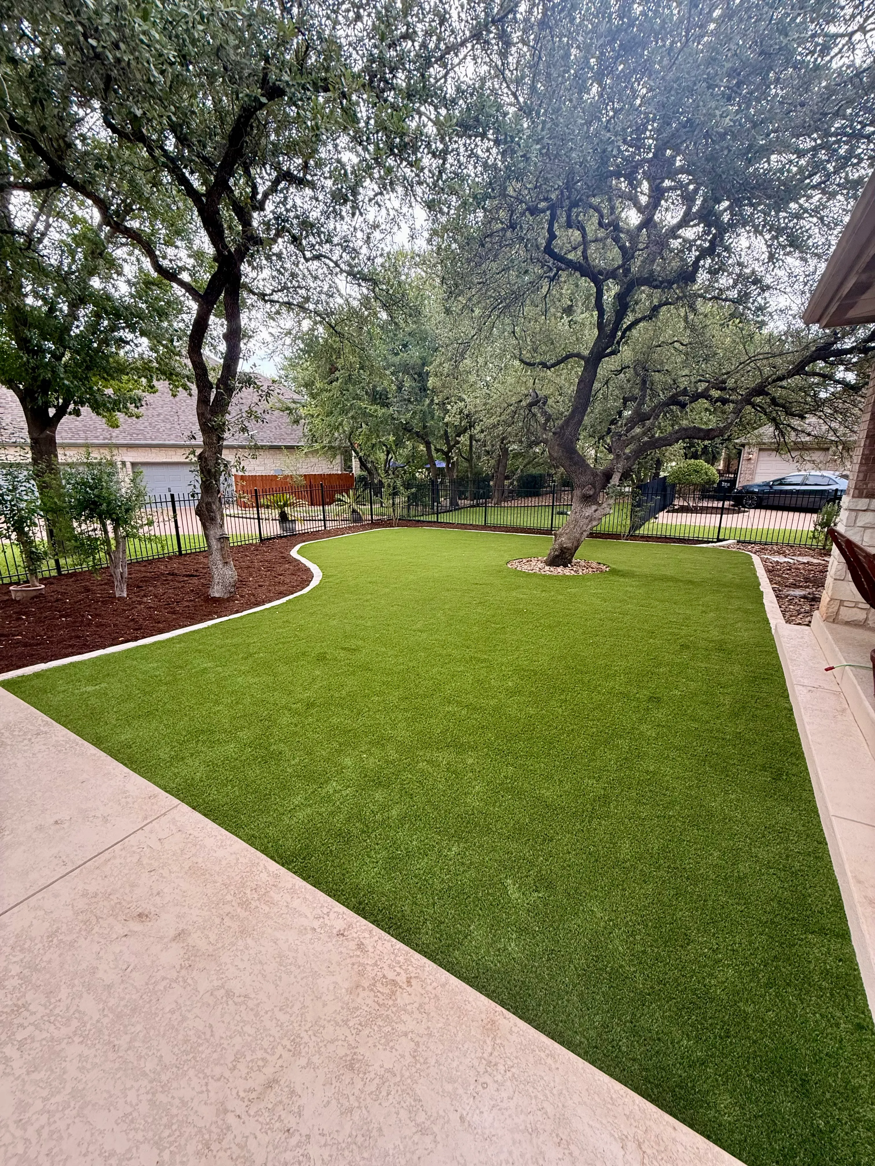 After 12 — Georgetown complete backyard renovation: turf, limestone, and living space under the live oaks