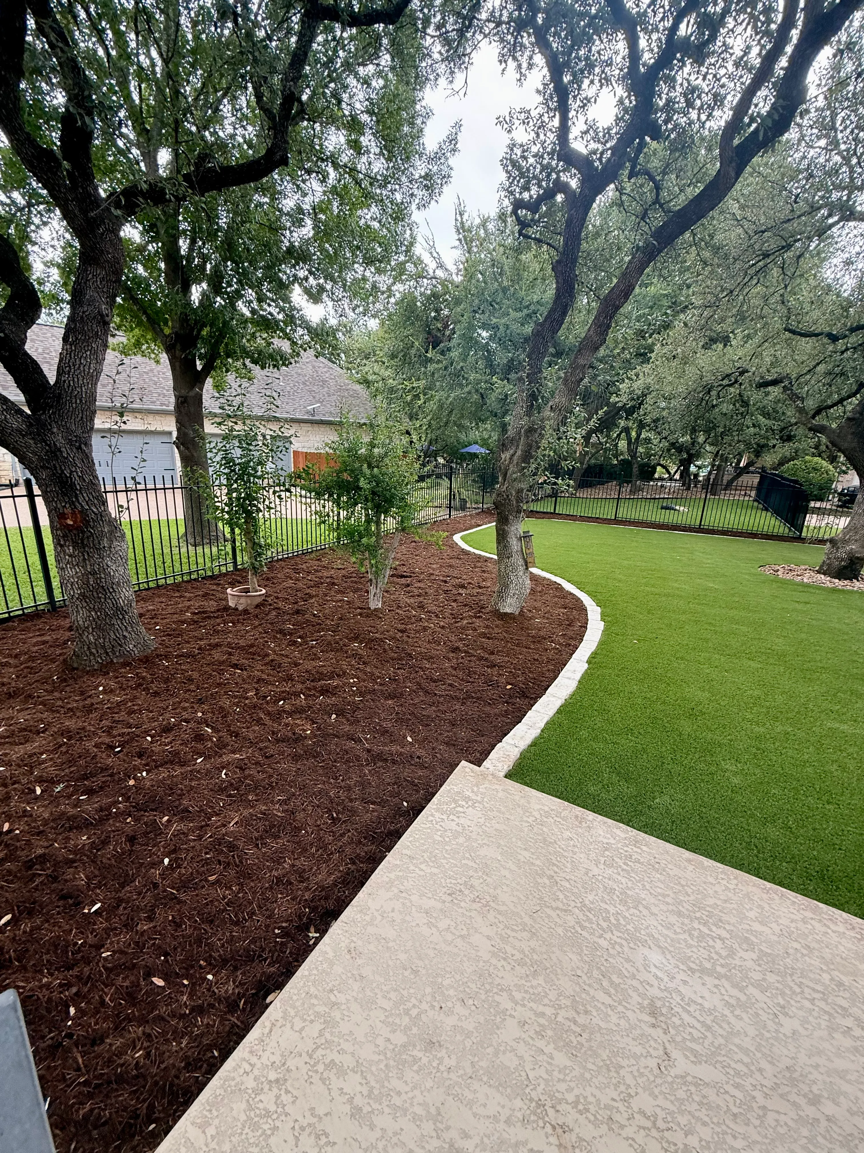 After 13 — Georgetown complete backyard renovation: turf, limestone, and living space under the live oaks