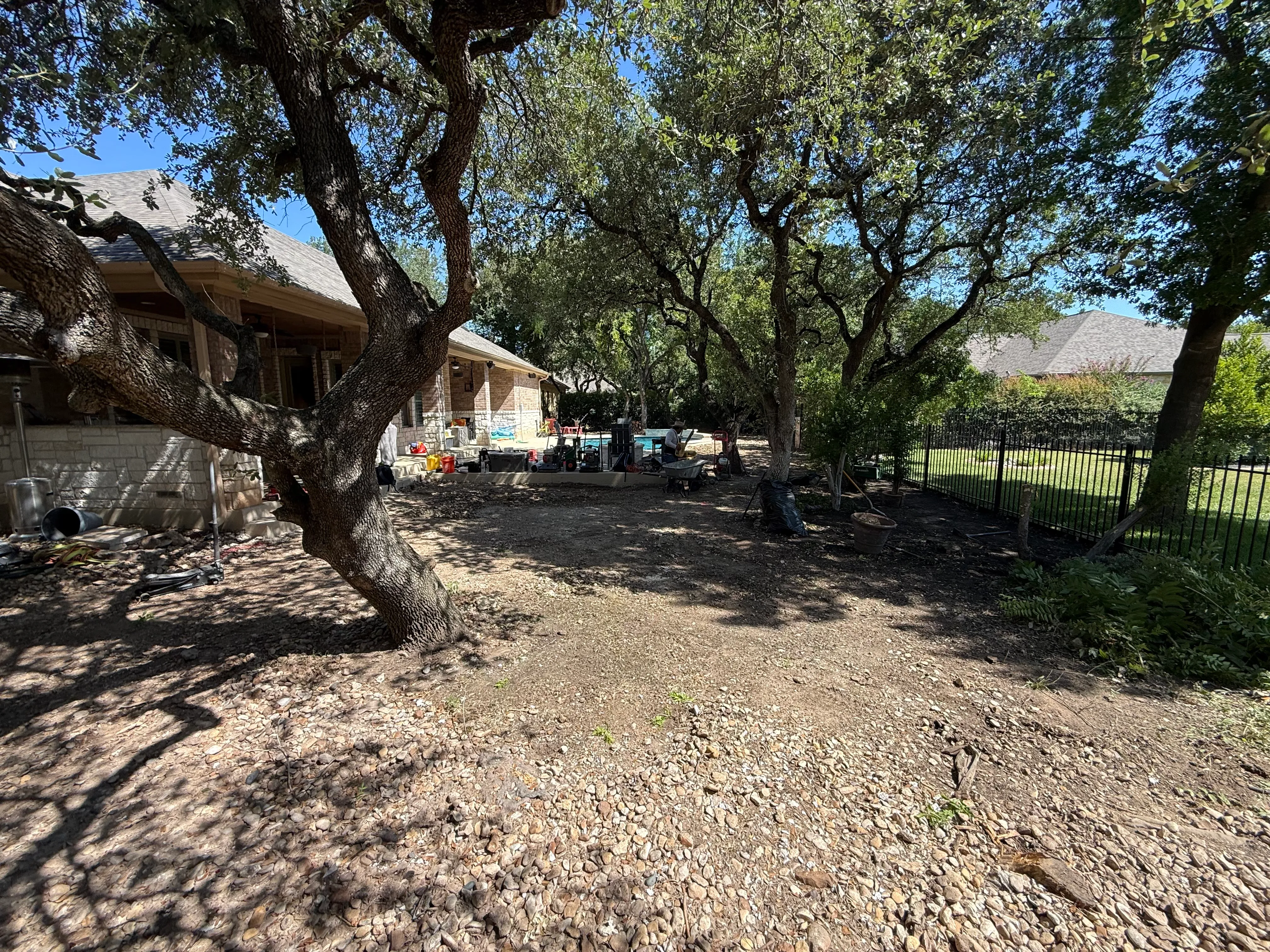 Before 2 — Georgetown complete backyard renovation: turf, limestone, and living space under the live oaks