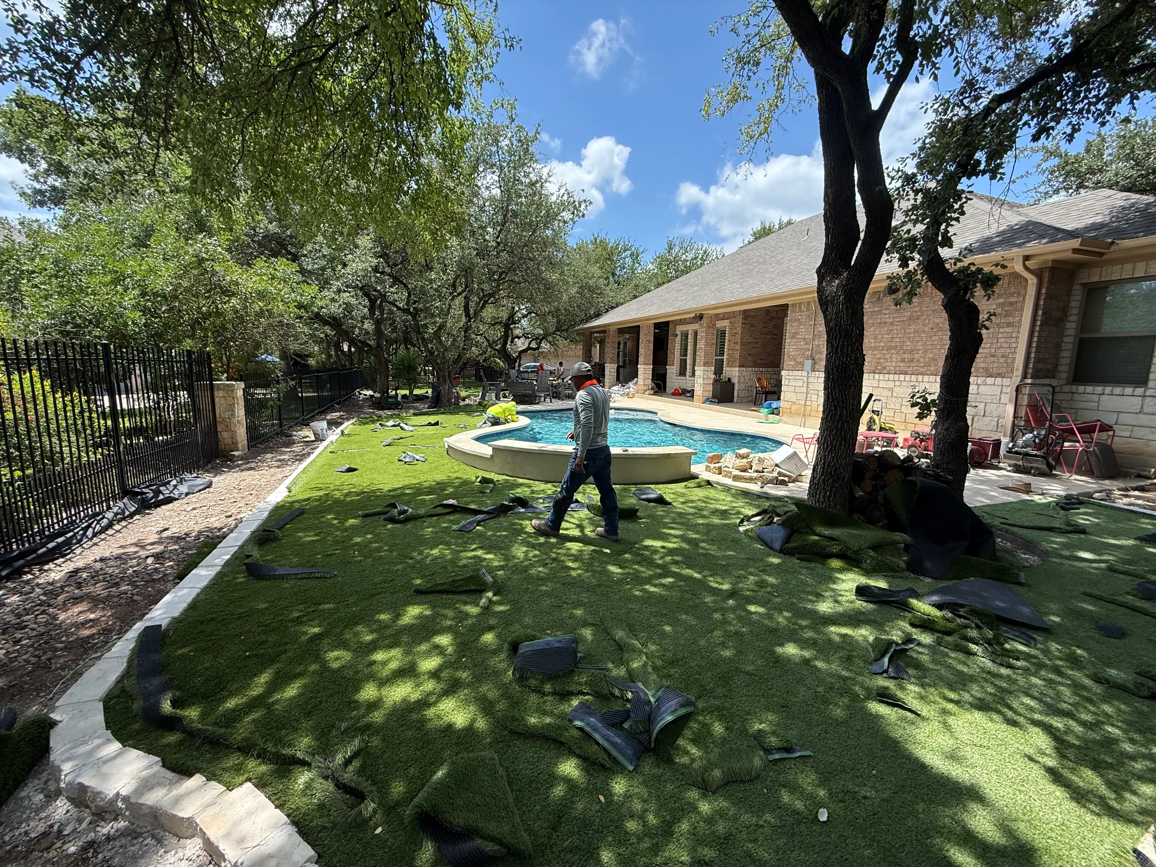 Construction 1 — Georgetown complete backyard renovation: turf, limestone, and living space under the live oaks