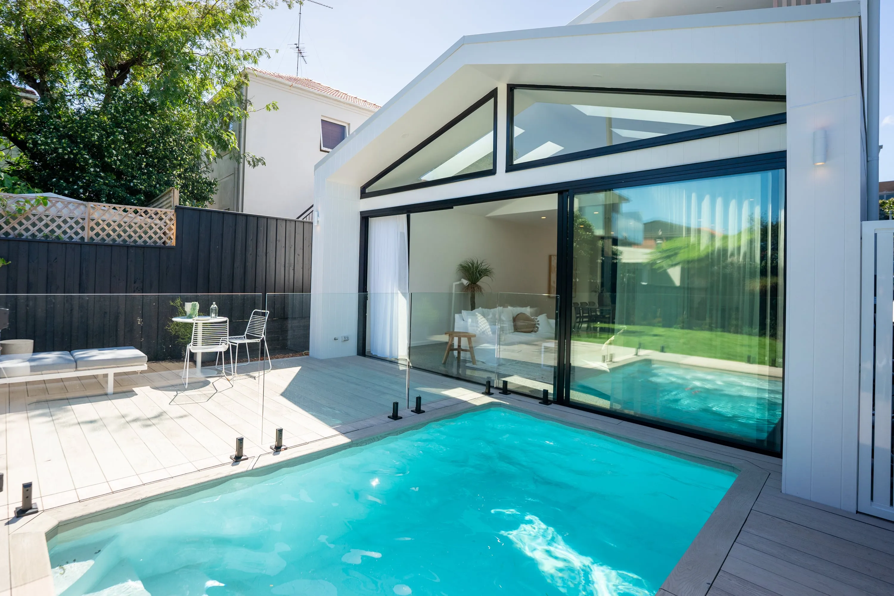 Bearcat-built complete backyard with pool, turf, decking, and outdoor living